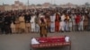 People gather to offer funeral prayers by the body of a Pakistani prisoner executed in January 2015. Pakistan lifted a six-year moratorium on the death penalty after militants killed more than 150 people at a school in the northwestern city of Peshawar in December 2014. 