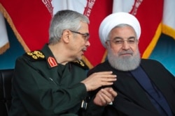 Iranian President Hassan Rohani (right) and the chief of the General Staff of the Armed Forces, General Mohammad Hossein Bagheri