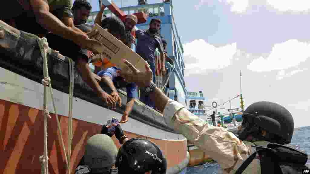 Sailors from the "U.S.S. Dewey" provide food, water and medical supplies to distressed Iranian fishermen in the Arabian Sea on 18 January. (AFP PHOTO/US NAVY-- Mass Communication Specialist 3rd Class Joshua Keim)
