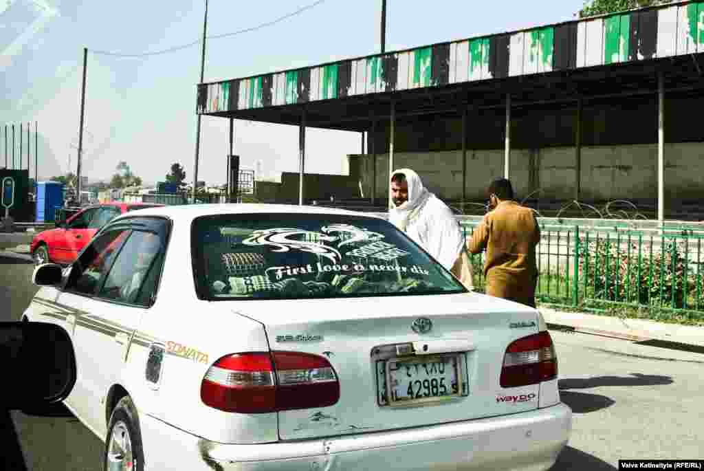 A car in Kabul decorated with an incorrectly spelled window sticker that is trying to say: &ldquo;First love never dies.&rdquo;