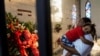 USA -- A mourner carries a child as he pays respects at Houston Memorial Gardens cemetery where George Floyd was buried, whose death in Minneapolis police custody has sparked nationwide protests against racial inequality, in Pearland, Texas, U.S., June 9,