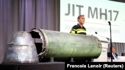 A part of the BUK-TELAR rocket that was fired at flight MH17 is displayed on a table during a JIT press conference in Bunnik, Netherlands, in May 2018.
