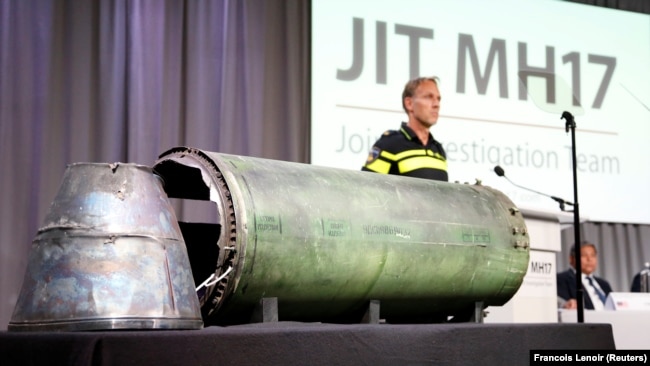 A part of the BUK-TELAR rocket that was fired at flight MH17 is displayed on a table during a JIT press conference in Bunnik, Netherlands, in May 2018.