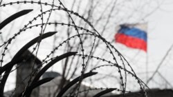 UKRAINE – A Russian flag is seen behind a barbwire on a fence of the Russian Embassy in Kyiv, 21 February 2022