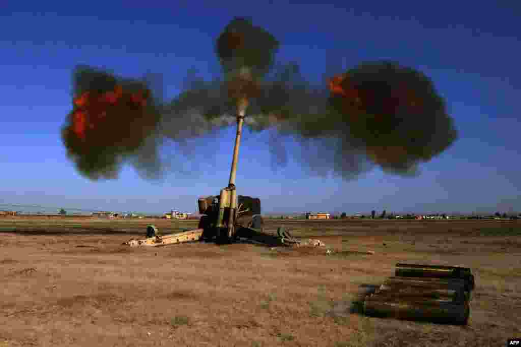 Iraqi fighters from the Abbas Brigade fire toward enemy positions in the village of Badush, some 15 kilometers northwest of Mosul, during the ongoing battle to retake the city from Islamic State militants. (AFP/Mohammed Sawaf)