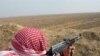 A member of an antiterrorist militia stands guard. Anbar Province has benefitted organized Sunni militias.