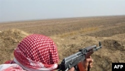 A member of an antiterrorist militia stands guard. Anbar Province has benefitted organized Sunni militias.