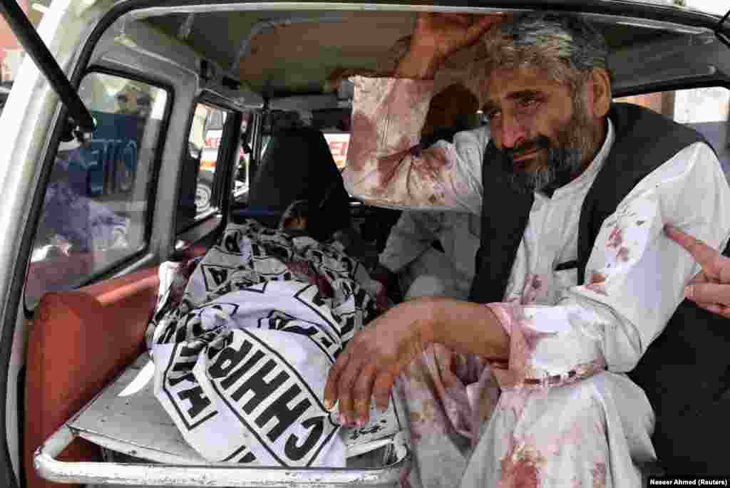 A man mourns for a friend or relative after a suicide bombing early on July 25 that killed 31 people outside a polling station in the southwestern city of Quetta, Pakistan. The Islamic State (IS) extremist group claimed responsibility for the attack.