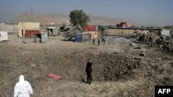 Afghan security personnel stand alert at the site after a powerful truck bomb targeting a hotel used by foreign contractors exploded on the outskirts of Kabul on August 1.