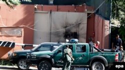 Afghan police stand guard outside the Heetal hotel in Kabul on May 27.