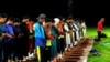 Players offering prayer in a cricket stadium that was later bit by blasts. 