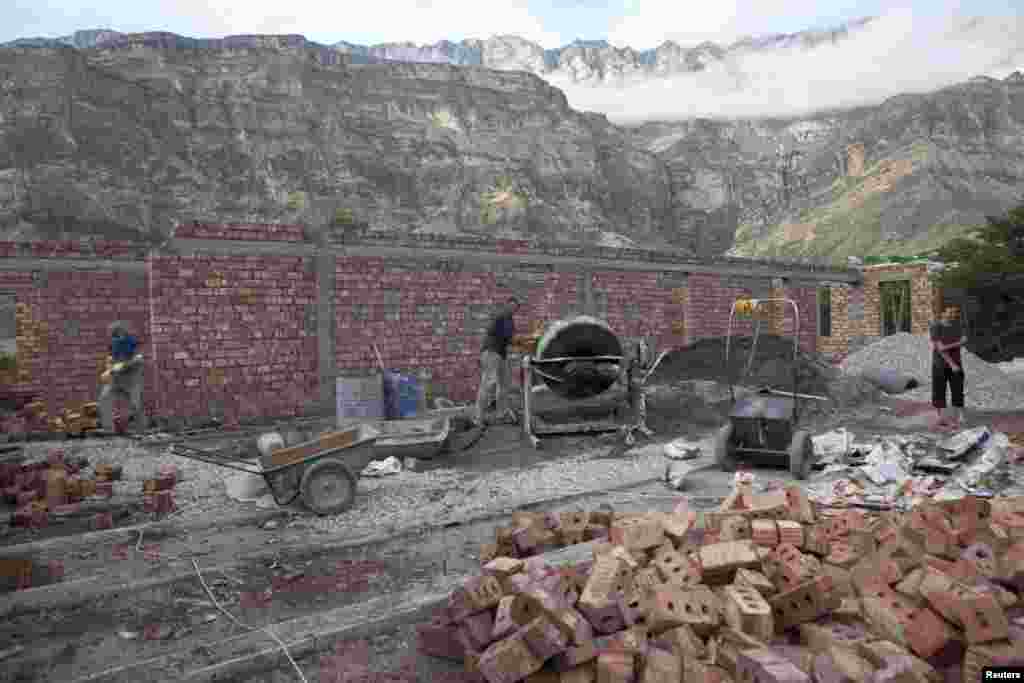 Men build a new madrasah, or religious school, in the village of Gimry.