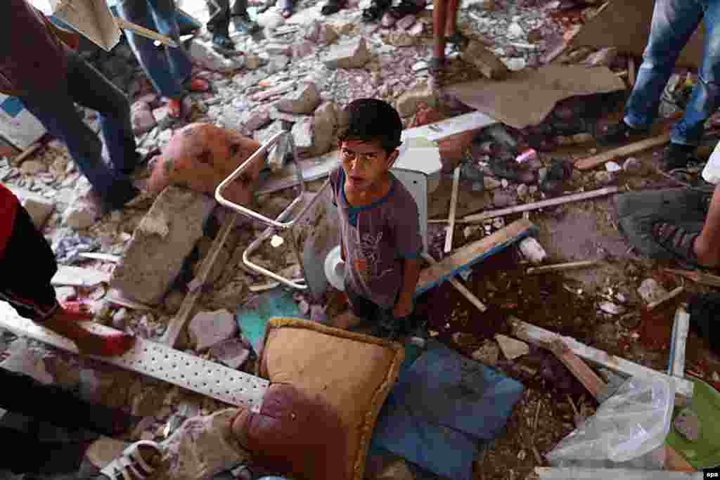 Palestinians inspect a damaged classroom of a UN school in Jabalia, northern Gaza Strip, after it was bombed by Israeli forces on July 30. (epa/Mohammed Saber)