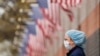 A nurse wearing personal protective equipment watches an ambulance driving away outside of Elmhurst Hospital during the ongoing outbreak of the coronavirus disease (COVID-19) in the Queens borough of New York, U.S., April 20, 2020. REUTERS/Lucas Jackson 