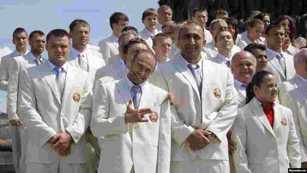 The Belarusian Olympic delegation poses in sleek white suits in Victory Square in Minsk before their departure for London.