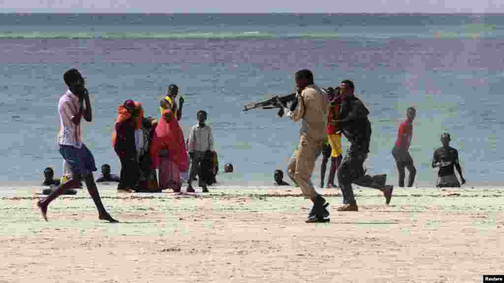 Somali police arrest a suspected member of the Al-Qaeda-affiliated Al-Shabaab group on Lido Beach on March 23. (Reuters/Feisal Omar)