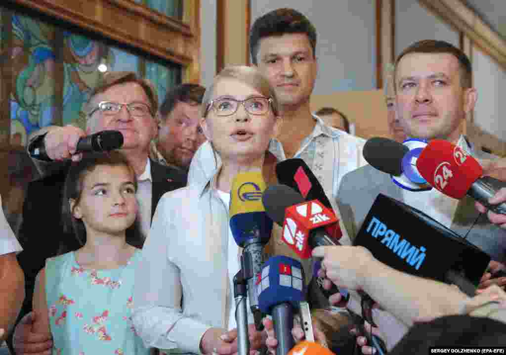 Yulia Tymoshenko, the leader of the Fatherland party, speaks with reporters after voting at a polling station in Kyiv. (EPA-EFE/Sergey Dolzhenko)