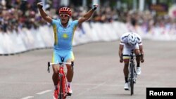 Kazakhstan's Aleksandr Vinokurov celebrates as he crossing the finish line in London to win the men's cycling road race at the London 2012 Olympic Games on July 28.