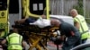 Ambulance staff take a man from outside a mosque in central Christchurch on March 15.