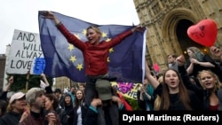 Crowds of demonstrators gather outside the Houses of Parliament during a protest aimed at showing London's solidarity with the European Union.