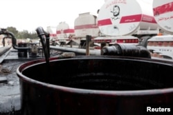 A barrel is filled with oil delivered from Iraq at the oil terminal of Baniyas, Syria, on May 14.