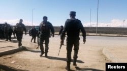 Afghan policemen arrive at the site of a blast in Kabul on March 1.