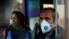 Tehran, Iran - An Iranian man wears a protective masks to prevent contracting coronavirus, as he sits in the bus in Tehran, Iran February 25, 2020.