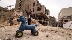 An Iranian man gestures as he stands near destroyed homes following a military strike on the Iranian capital, Tehran, on March 15.