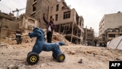 An Iranian man gestures as he stands near destroyed homes following a military strike on the Iranian capital, Tehran, on March 15.