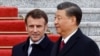 Chinese President Xi Jinping (right) welcomes French President Emmanuel Macron at the Great Hall of the People in Beijing on April 6.