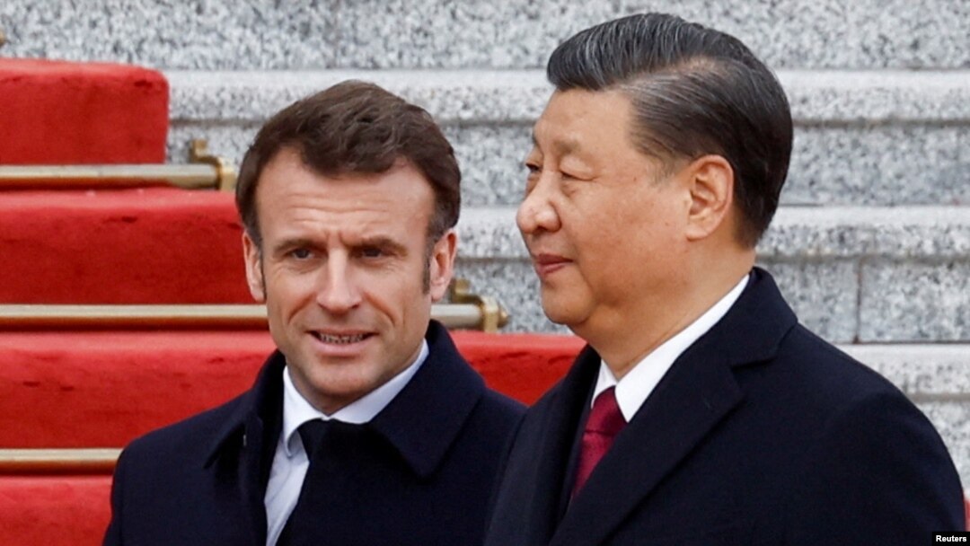 Chinese President Xi Jinping (right) welcomes French President Emmanuel Macron at the Great Hall of the People in Beijing on April 6.