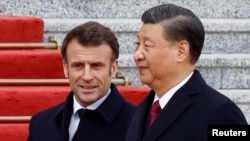 Chinese President Xi Jinping (right) welcomes French President Emmanuel Macron at the Great Hall of the People in Beijing on April 6.