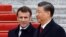 Chinese President Xi Jinping (right) welcomes French President Emmanuel Macron at the Great Hall of the People in Beijing on April 6.