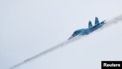 A Russian Sukhoi Su-34 fighter bomber jet fires missiles during the Aviadarts competition outside Ryazan in 2021.