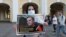 A woman in St. Petersburg holds up a poster in support of Aleksei Navalny, a popular Russian opposition leader whose poisoning on August 20 could leave him incapacitated for months. 
