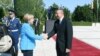 German Chancellor Angela Merkel (left) is greeted by Azerbaijani President Ilham Aliyev in Baku on August 25. 