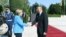 German Chancellor Angela Merkel (left) is greeted by Azerbaijani President Ilham Aliyev in Baku on August 25. 
