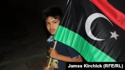 A boy with the anti-Qaddafi Libyan flag in Zawahiya on August 24