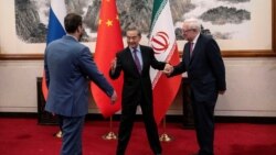 Chinese Foreign Minister Wang Yi welcomes Russian Deputy Foreign Minister Sergey Ryabkov and Iranian Deputy Foreign Minister Kazem Gharibabadi, before a meeting regarding the Iranian nuclear issue at Diaoyutai State Guest House on March 14, 2025, in Beijing, China