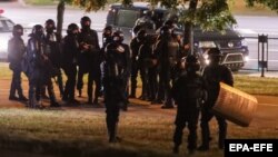 Belarusian police block a street during protests in Minsk early on August 13.