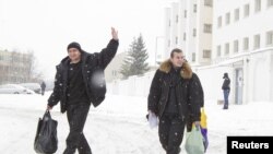 Men walk after being released from a detention center in Minsk more than a week after their detention during election-related protests.