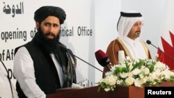 FILE -- Muhammad Naeem (L), a spokesman for the Office of the Afghan Taliban speaks during the opening of the Taliban Afghanistan Political Office in Doha (June, 2013). 