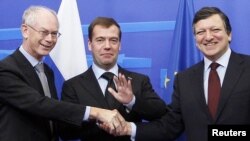 Russian President Dmitry Medvedev (center) is welcomed by European Council President Herman Van Rompuy (left) and European Commission President Jose Manuel Barroso ahead of the Brussels summit.