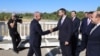 Armenia/Turkey - Armenian parliament vice-speaker Ruben Rubinian (right) greets Turkish envoy Serdar Kilic on a Turkish-Armenian border bridge, September 12, 2025.