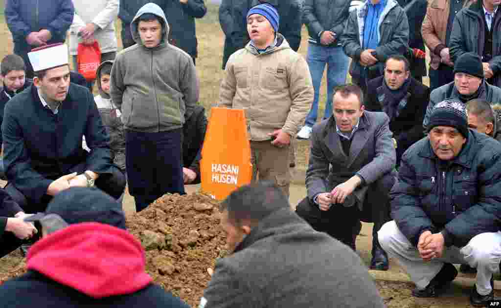 Sarajevo residents and family members pray during the burial ceremony on January 8 in front of the chapel at a Sarajevo cemetery.