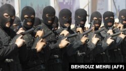 FILE: Iranian anti-narcotics police special forces hold their guns during a drill at a ceremony concluding maneuvers against drug smuggling in Iran's southeastern city of Zahedan, which is the capital of Sistan-Baluchestan.