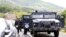 KOSOVO -- Kosovo special police with armored vehicles stand on the road near the northern Kosovo border crossing of Jarinje, September 20, 2021