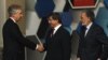 Turkish Foreign Minister Ahmet Davutoglu (center), accompanied by his Afghan counterpart Zalmay Rasul (right), shakes hands with U.S. Deputy Secretary of State William Burns before the Istanbul Conference on November 2.