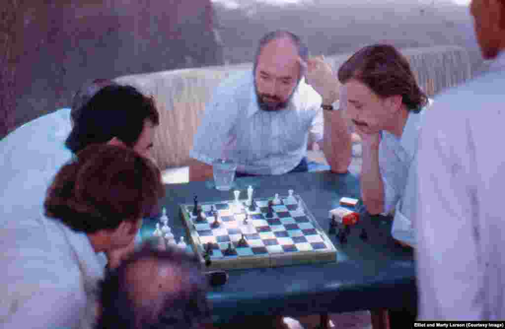 A game of chess being played by two Afghan doctors. The bearded American in the middle is Dr. Edwin Brown, who was visiting Elliot&#39;s Jalalabad facility. He died in the spring of 2015.