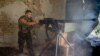 A Ukrainian serviceman fires rounds from a machine gun during fighting in eastern Ukraine. (file photo)